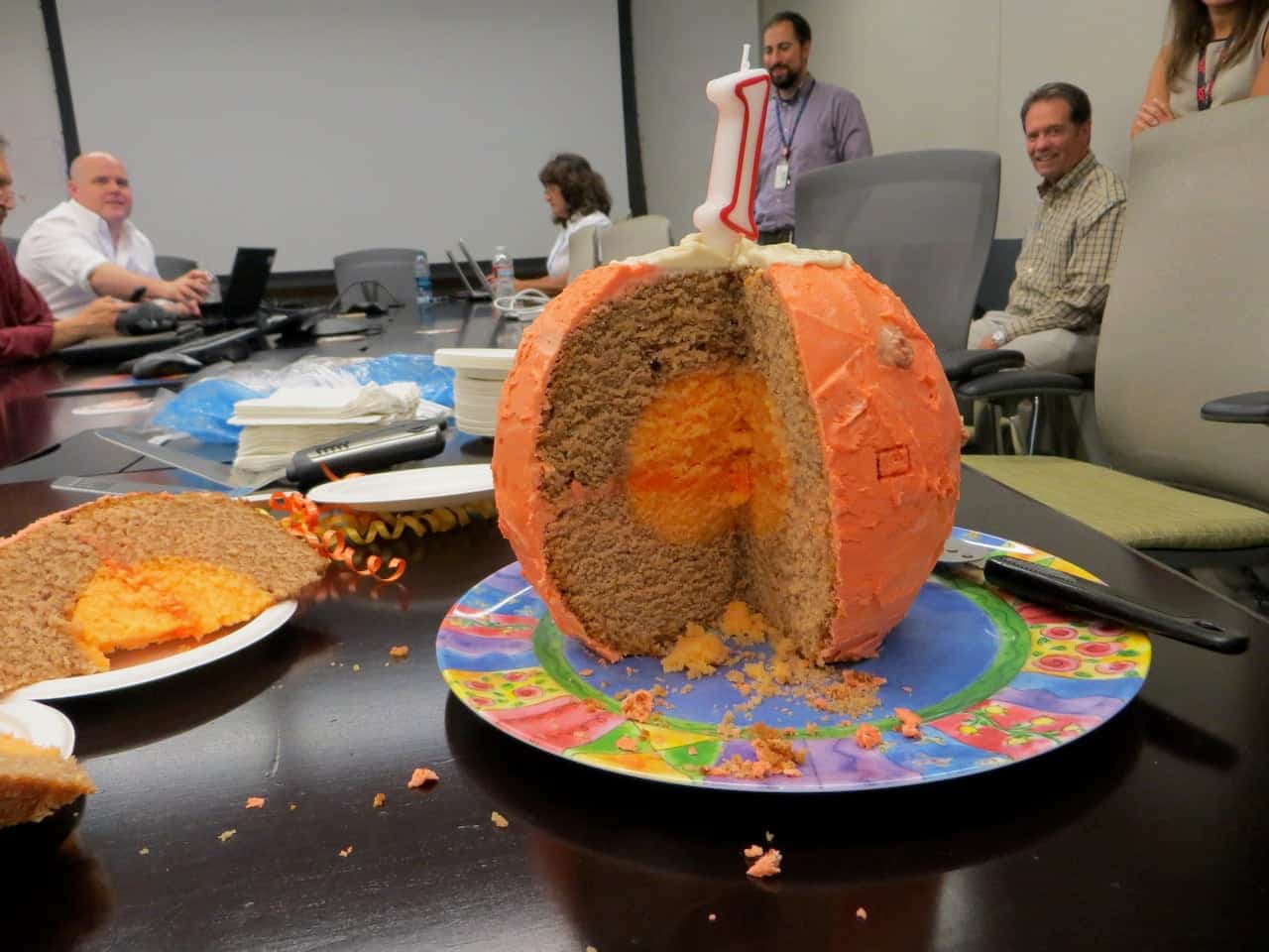 كعكة على شكل كوكب المريخ مع شمعة عيد ميلاد على شكل رقم 1 في الأعلى.